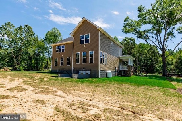 rear view of house with a lawn