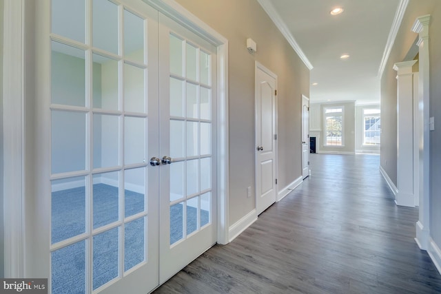 hall featuring hardwood / wood-style floors, crown molding, and french doors