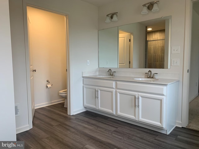 bathroom featuring hardwood / wood-style flooring, vanity, and toilet