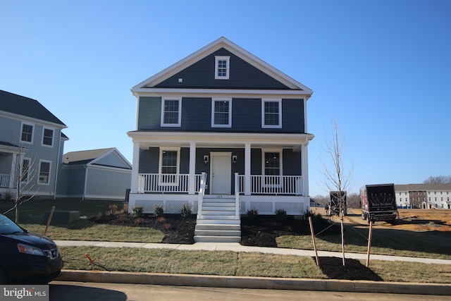 view of front of house with a porch and a front yard