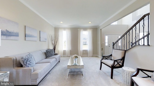 carpeted living room featuring crown molding and plenty of natural light