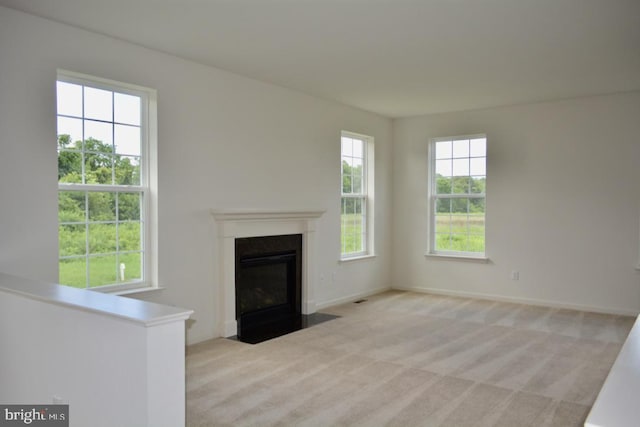 unfurnished living room featuring light carpet