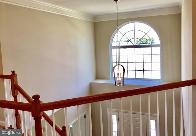 interior space featuring ornamental molding and a chandelier