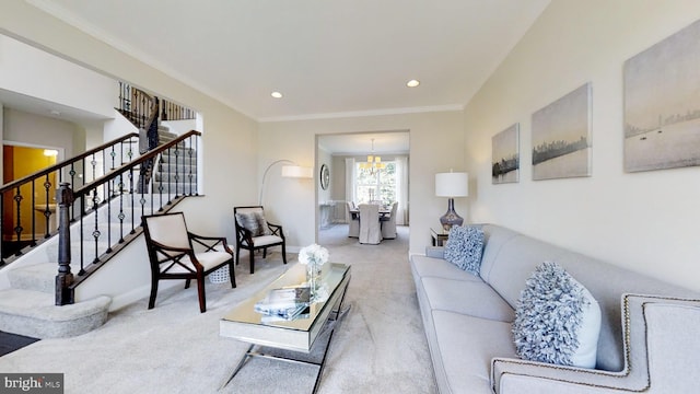 carpeted living room with ornamental molding and a chandelier