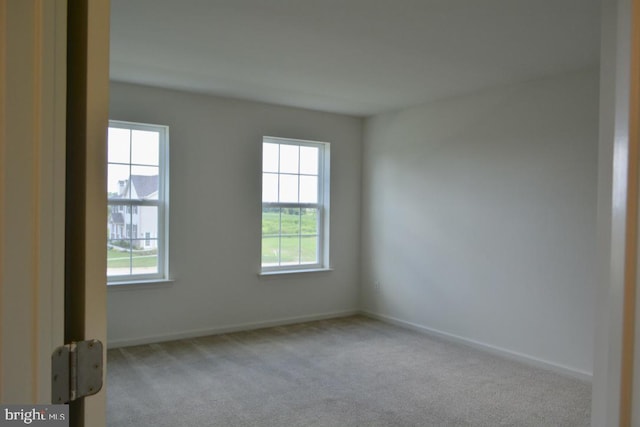 carpeted spare room with a healthy amount of sunlight