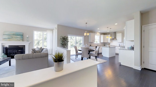 living room featuring a notable chandelier and dark wood-type flooring