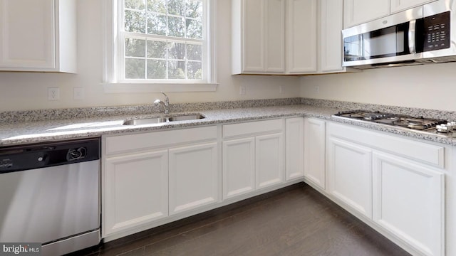 kitchen featuring dark hardwood / wood-style floors, stainless steel appliances, white cabinets, and sink