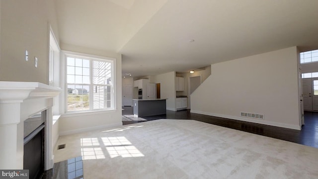 unfurnished living room featuring dark hardwood / wood-style flooring