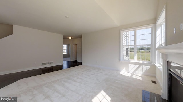 unfurnished living room with carpet floors