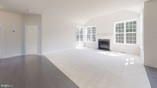 unfurnished living room with lofted ceiling and dark hardwood / wood-style flooring