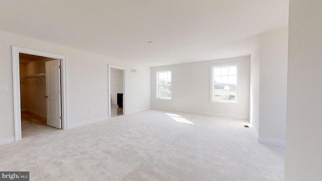 unfurnished room featuring light colored carpet