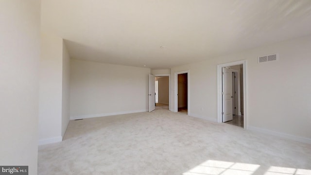 spare room with light colored carpet