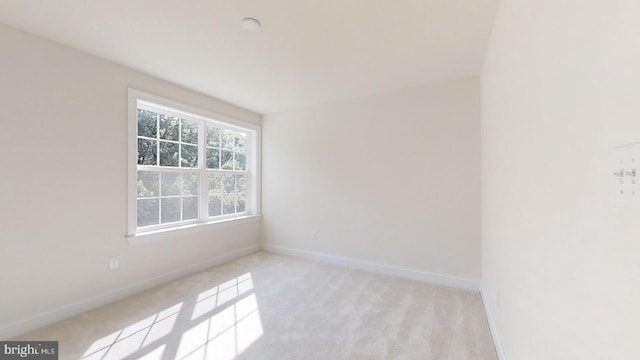 empty room featuring light carpet