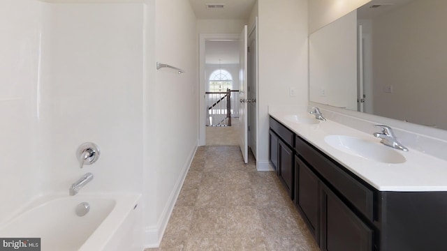 bathroom featuring double sink, large vanity, and tile floors