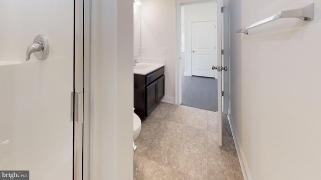 bathroom with oversized vanity, tile flooring, toilet, and walk in shower