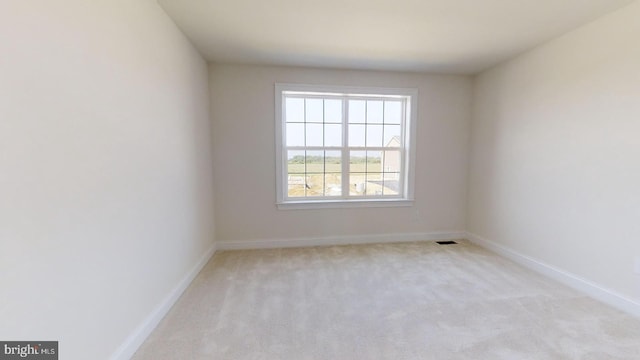 unfurnished room with light carpet