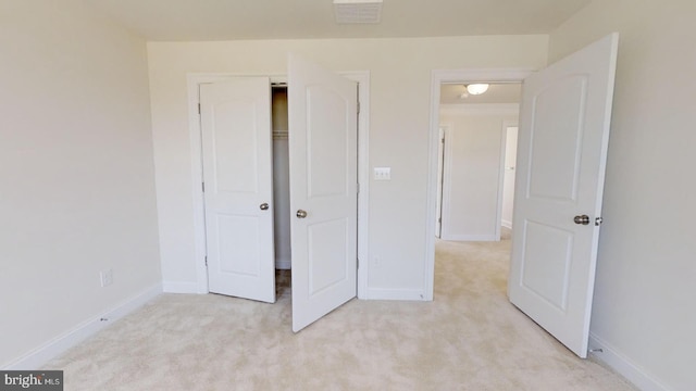 unfurnished bedroom featuring light colored carpet