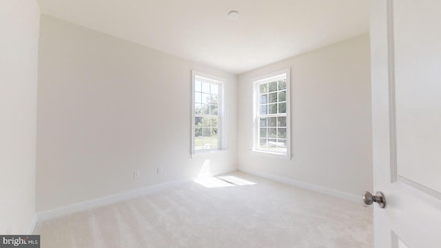 unfurnished room with light colored carpet