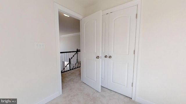 unfurnished bedroom with light carpet and a closet