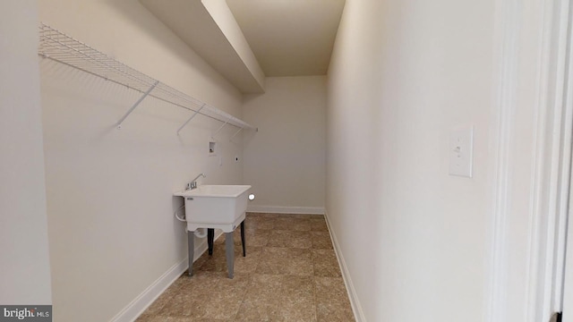 clothes washing area featuring light tile flooring and hookup for a washing machine