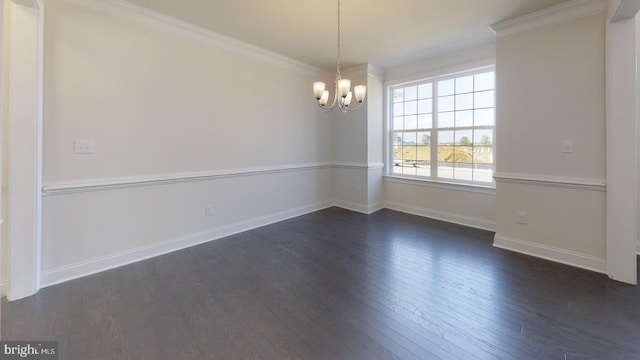 spare room with crown molding, dark hardwood / wood-style floors, and a notable chandelier