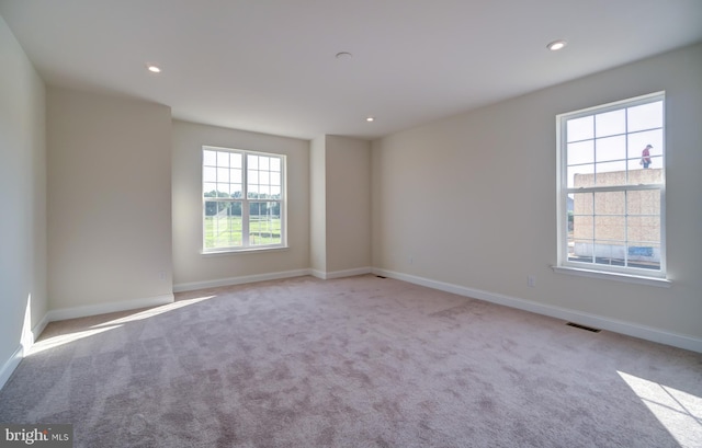 empty room featuring light colored carpet