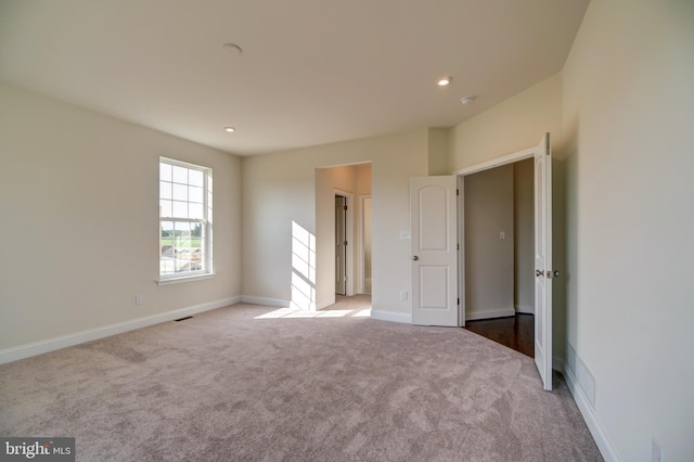 empty room with light colored carpet