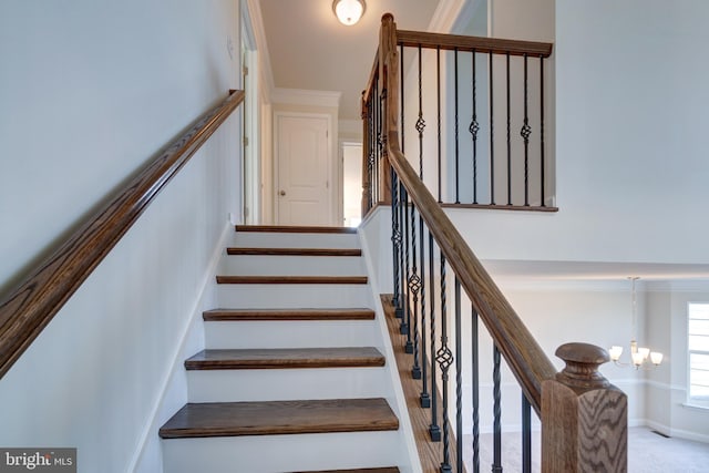 staircase featuring a chandelier and light colored carpet