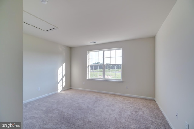 unfurnished room with light carpet