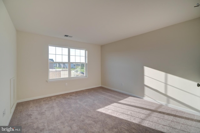 unfurnished room featuring light colored carpet