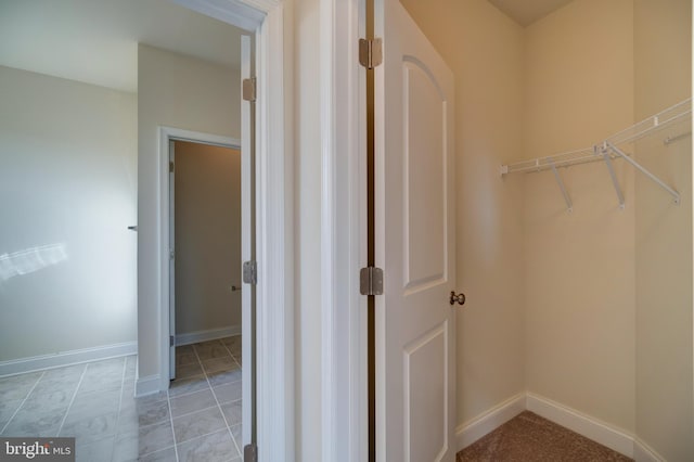 spacious closet featuring light tile floors