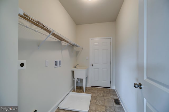 laundry area with hookup for an electric dryer, washer hookup, and light tile flooring