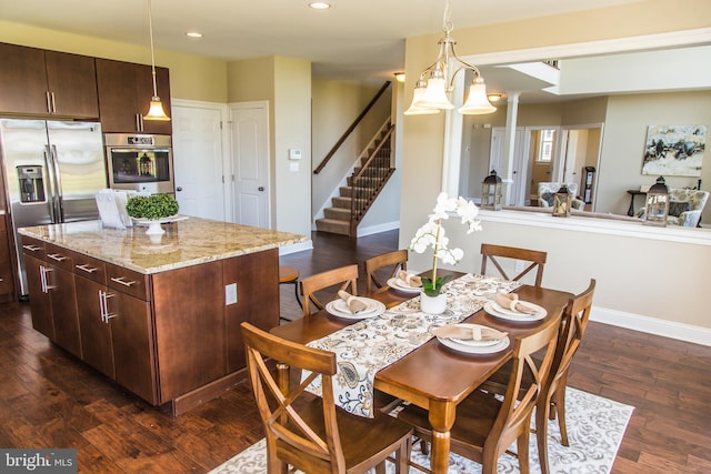 dining room featuring a chandelier and dark hardwood / wood-style flooring