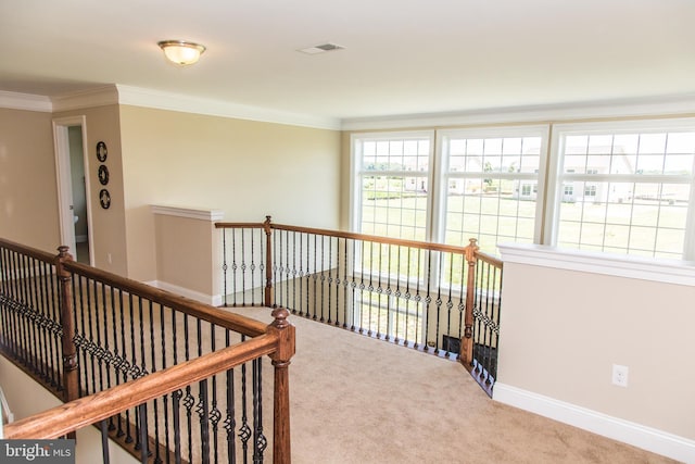 corridor featuring light carpet and crown molding