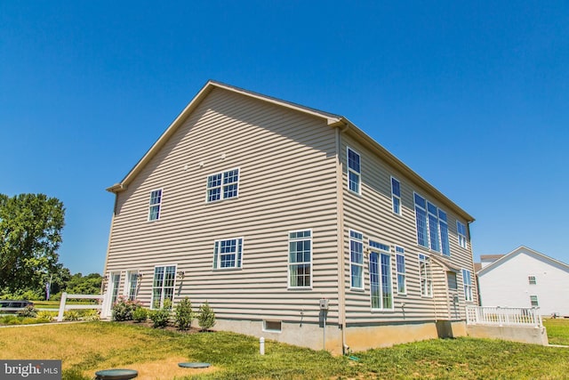 view of home's exterior with a yard