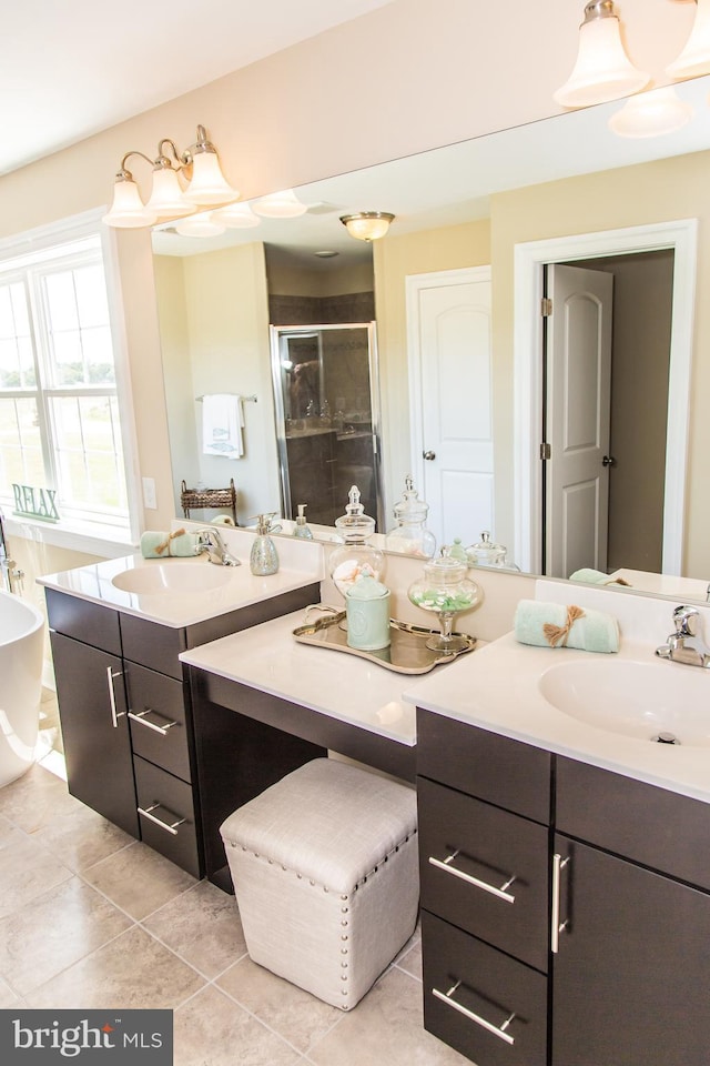 bathroom featuring independent shower and bath, vanity with extensive cabinet space, and tile flooring