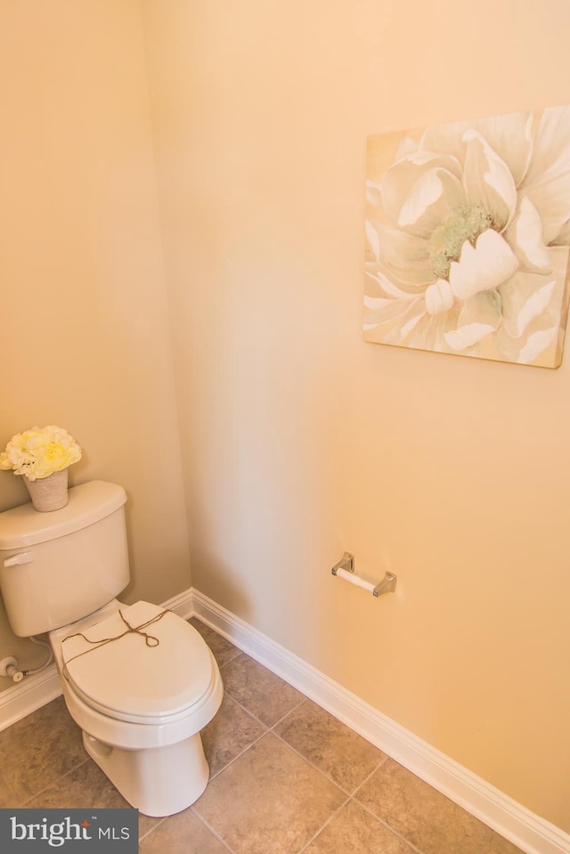 bathroom with tile flooring and toilet