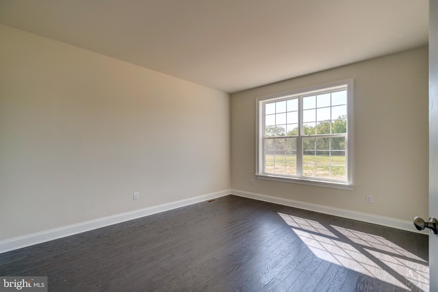 unfurnished room with dark hardwood / wood-style floors