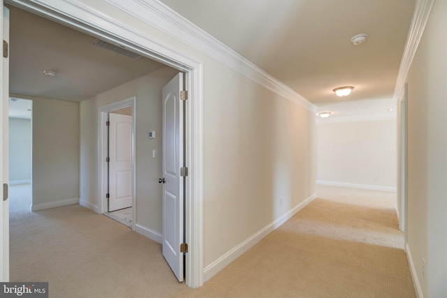 hall featuring ornamental molding and light colored carpet