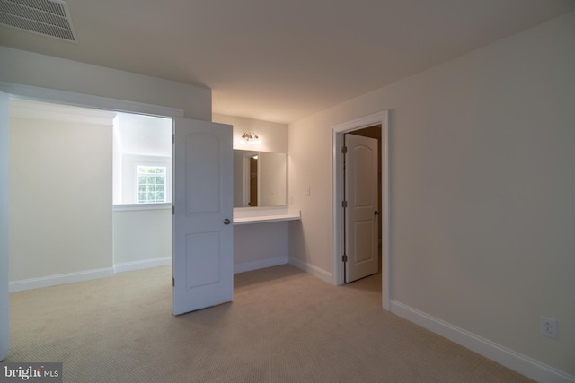 unfurnished bedroom with light colored carpet