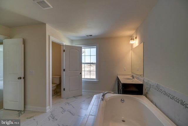 bathroom with tile flooring, toilet, vanity, and a tub