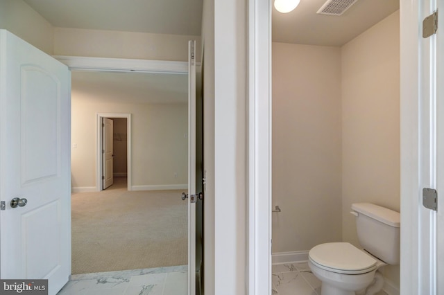 bathroom featuring tile floors and toilet