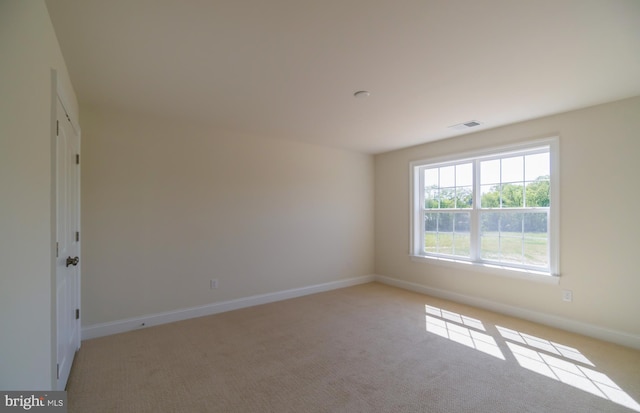 empty room with light colored carpet