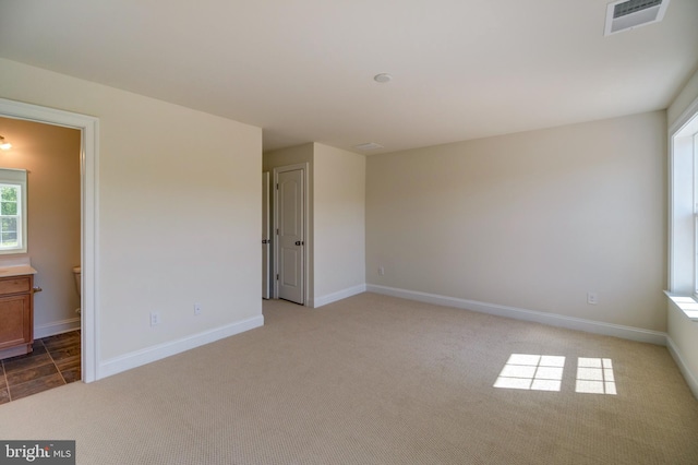 spare room with light colored carpet