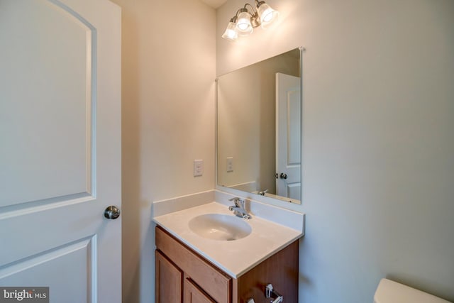 bathroom featuring toilet and vanity