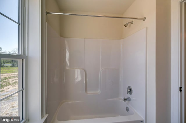 bathroom with bathtub / shower combination and plenty of natural light