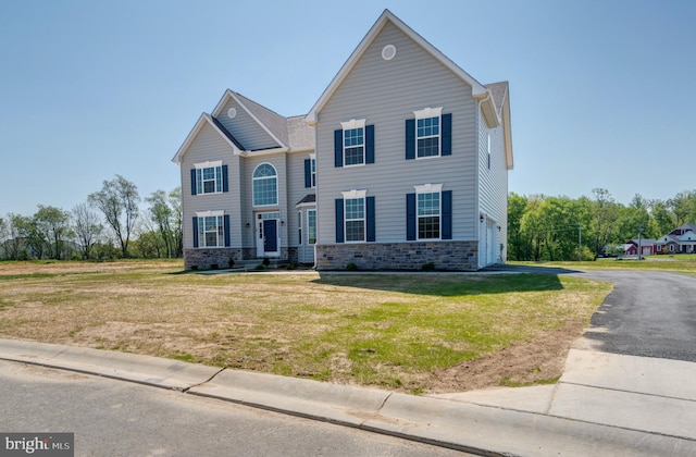 view of front of house with a front lawn and a garage