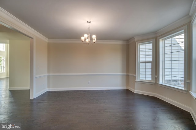 spare room with dark hardwood / wood-style flooring, a wealth of natural light, and a chandelier