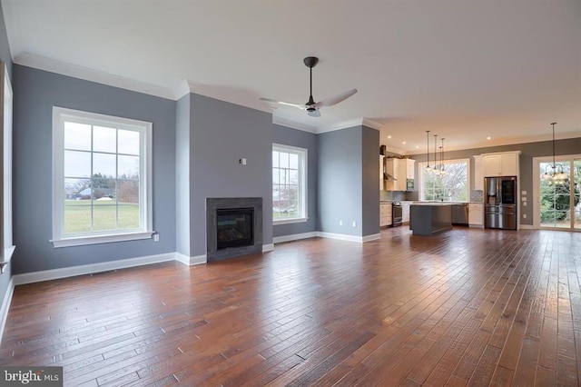 unfurnished living room with plenty of natural light and dark wood-type flooring