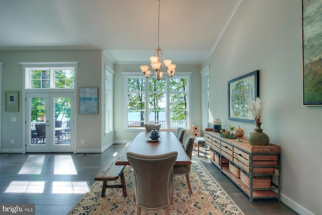 dining area with an inviting chandelier, ornamental molding, plenty of natural light, and french doors